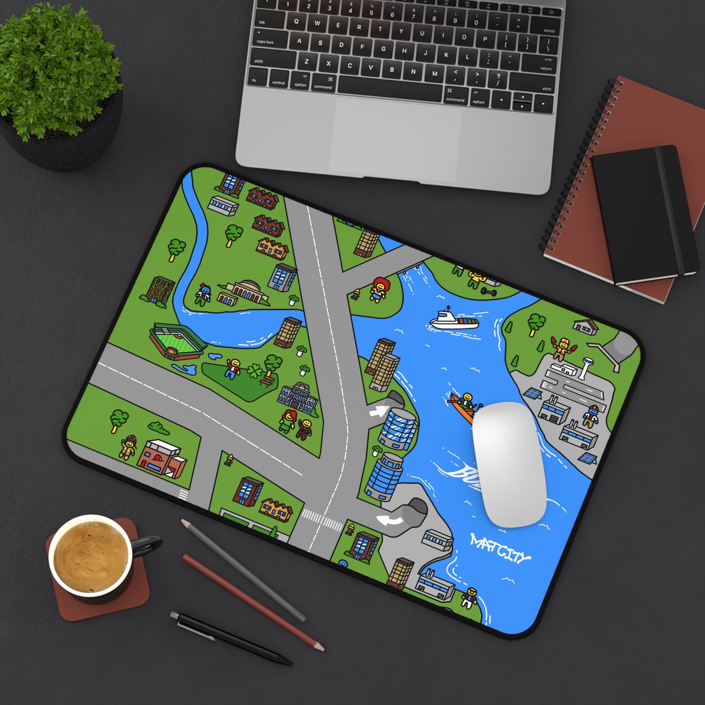 The Matcity Boston Mouse Mat Medium on a desk, with a mouse and laptop resting on it, showcasing its practical size and bright design.