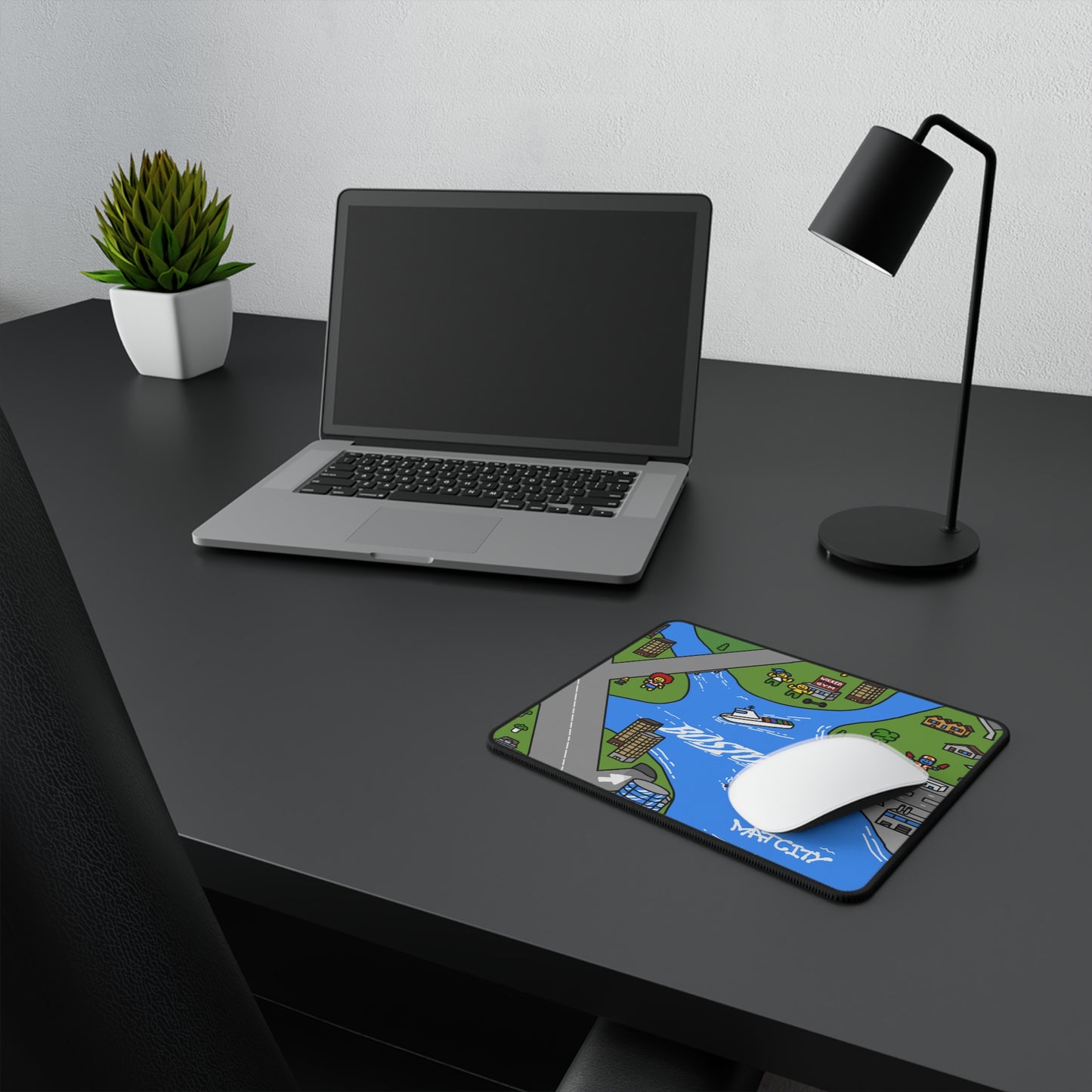 The small Boston mat placed on a desk with a laptop, lamp, and plant, illustrating how it fits compact spaces and complements minimalist setups.