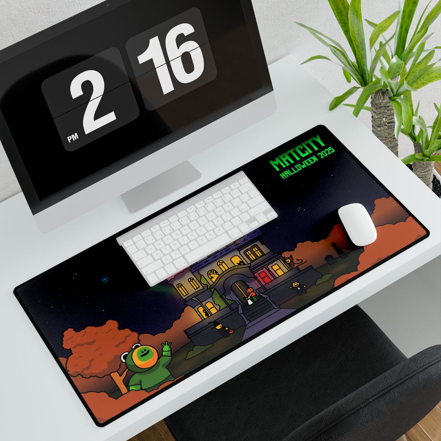 Large Matcity Halloween 2025 Mouse Pad placed on a white desk beneath a keyboard and mouse, displaying a haunted house design.