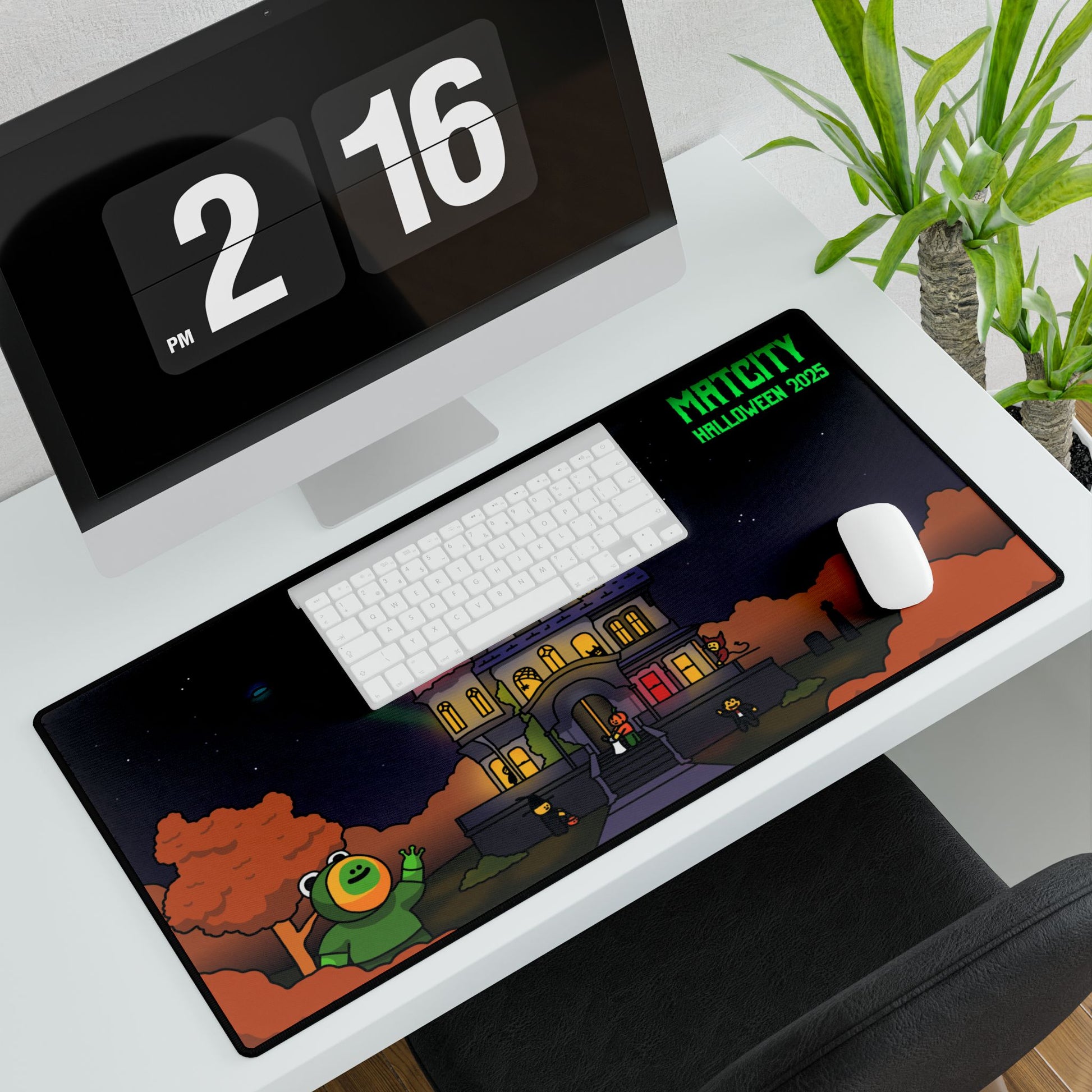 Large Matcity Halloween 2025 Mouse Pad placed on a white desk beneath a keyboard and mouse, displaying a haunted house design.