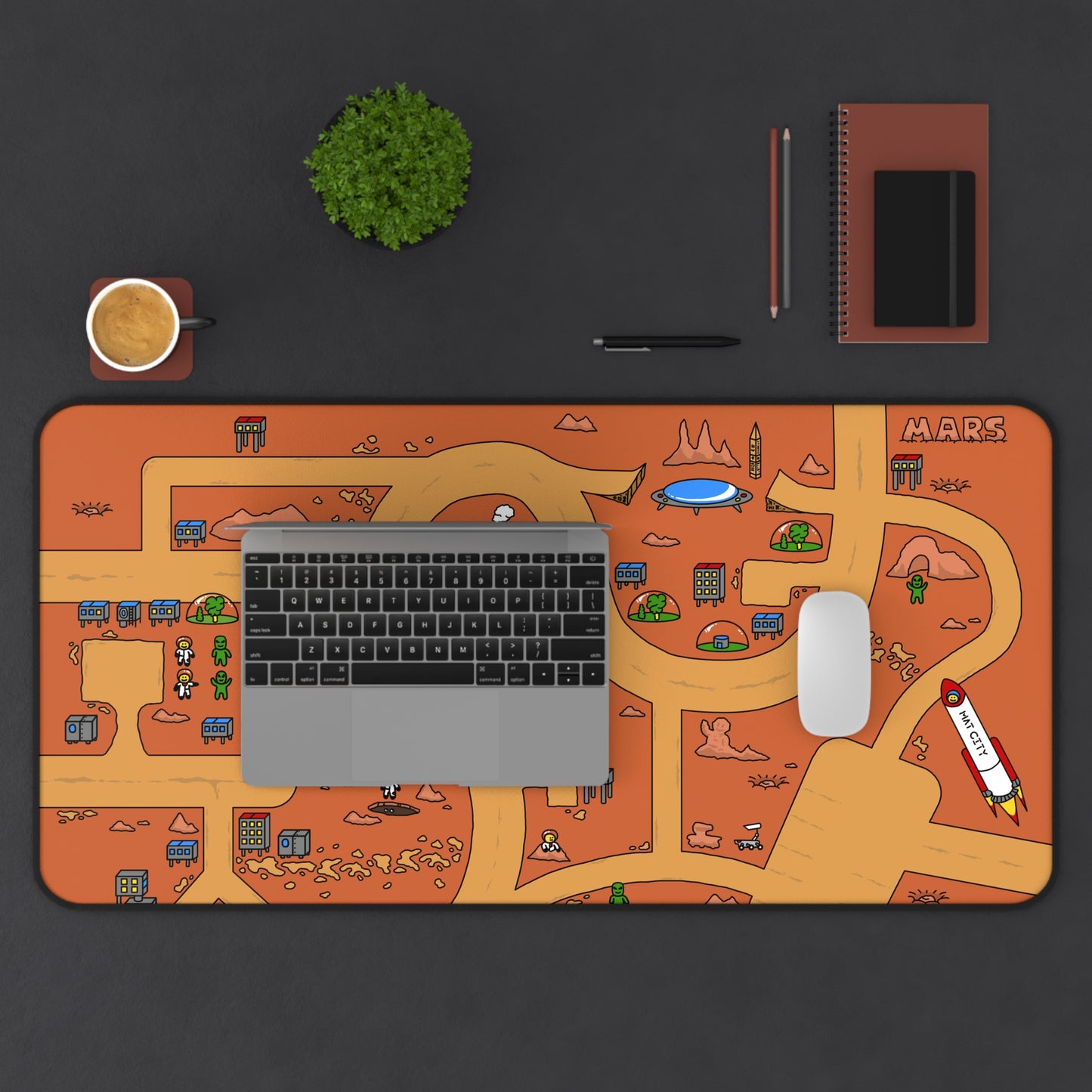 Overhead view of a desk setup featuring the Matcity Mars Mouse Mat Large under a laptop and mouse, highlighting the playful design of a Martian scene and pathways.