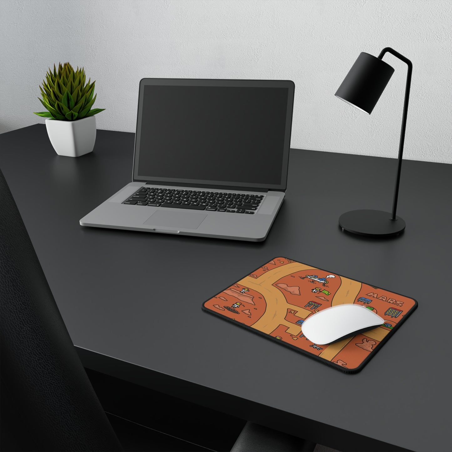 A sleek desk setup with a laptop, notebook, and a white mouse resting on the Matcity Mars Mouse Mat Small, adding a colorful touch to the minimalist workspace.