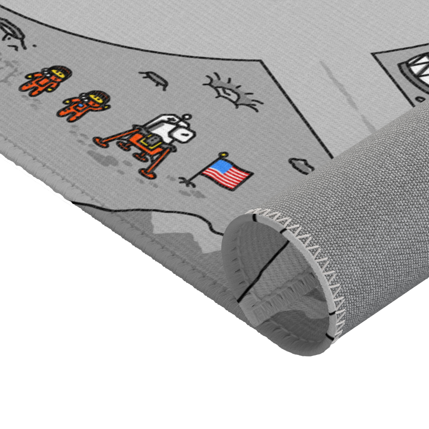 A close-up of the Matcity Moon Mat, partially rolled. The image showcases the durable fabric and stitching with a focus on the lunar base design, including astronauts and a U.S. flag.