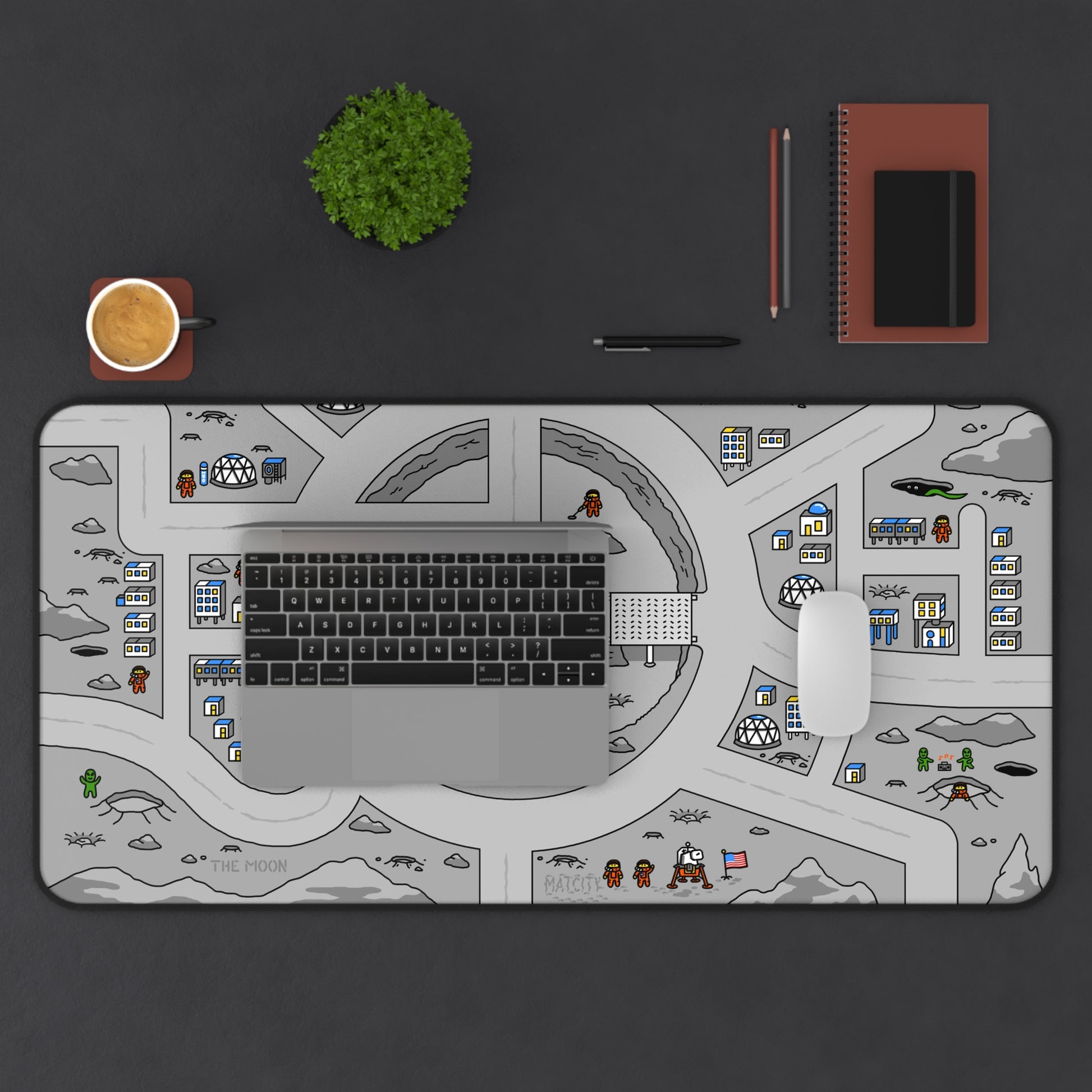 Matcity Moon Mat Large on a desk under a laptop, mouse, and plant, featuring lunar craters, space domes, and astronaut figures.