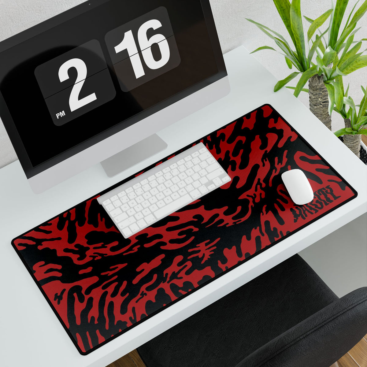 Desk setup with a large Red Tieger camouflage patterned mouse pad large, computer monitor, keyboard, and mouse.