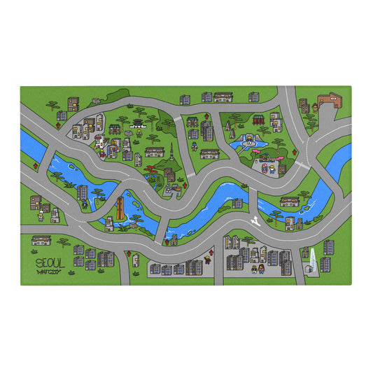 A full view of the Matcity Seoul play mat, showcasing a colorful cityscape with winding roads, rivers, and detailed buildings. The bottom left corner features the "Seoul Matcity" logo.