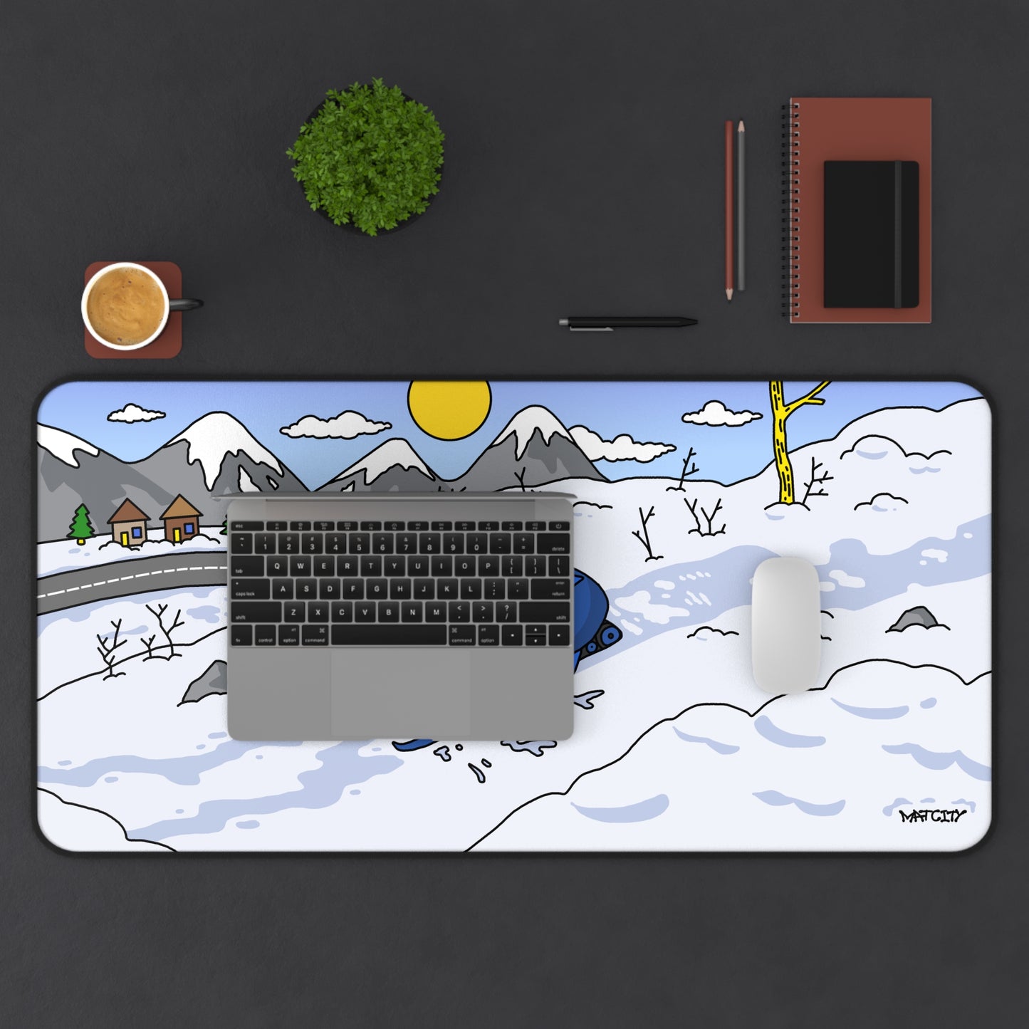 Overhead view of a desk with Snow Rally Mousepad Large, showing the sled design partially covered by a laptop and mouse.
