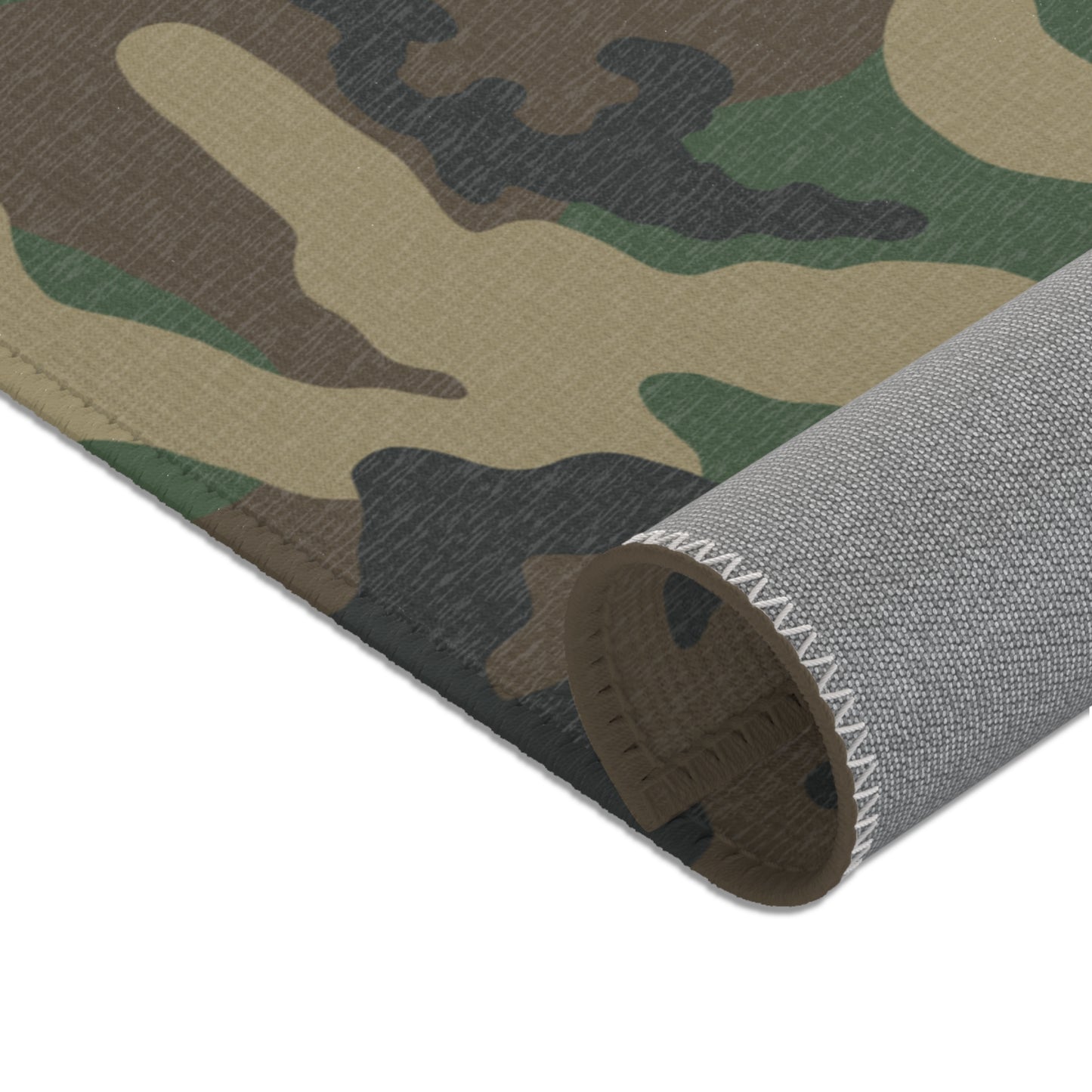 Woodland camouflage patterned rug with a textured gray underside shown on a white background