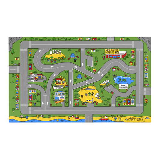 An overhead view of the Matcity Atozy mat, featuring colorful roads, buildings, and landmarks such as "Drop Shipped Burgers" and "Lame Lawsuit Defense HQ," with playful scenes across a green landscape.