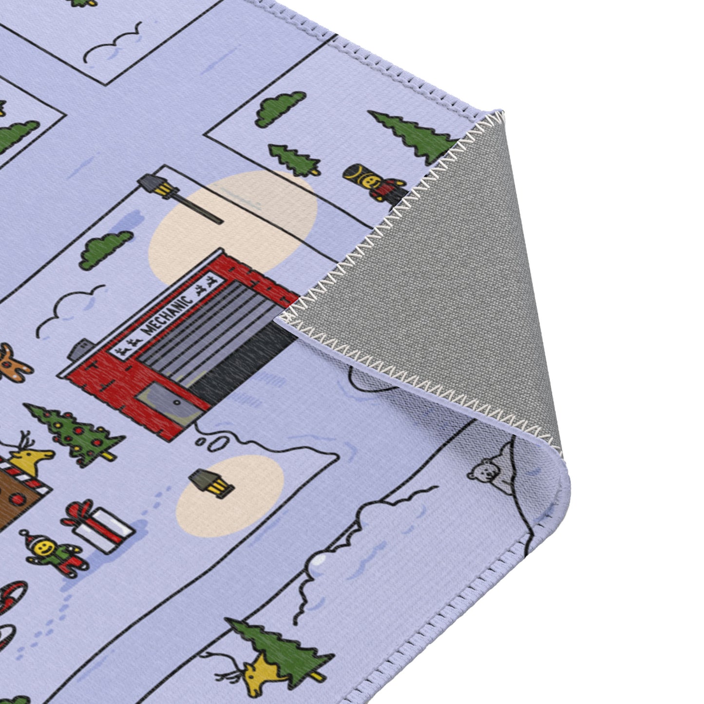Close-up of the folded corner of the Santa's Village Mat, showcasing its soft, durable material and precise stitching along the edges for a polished finish.