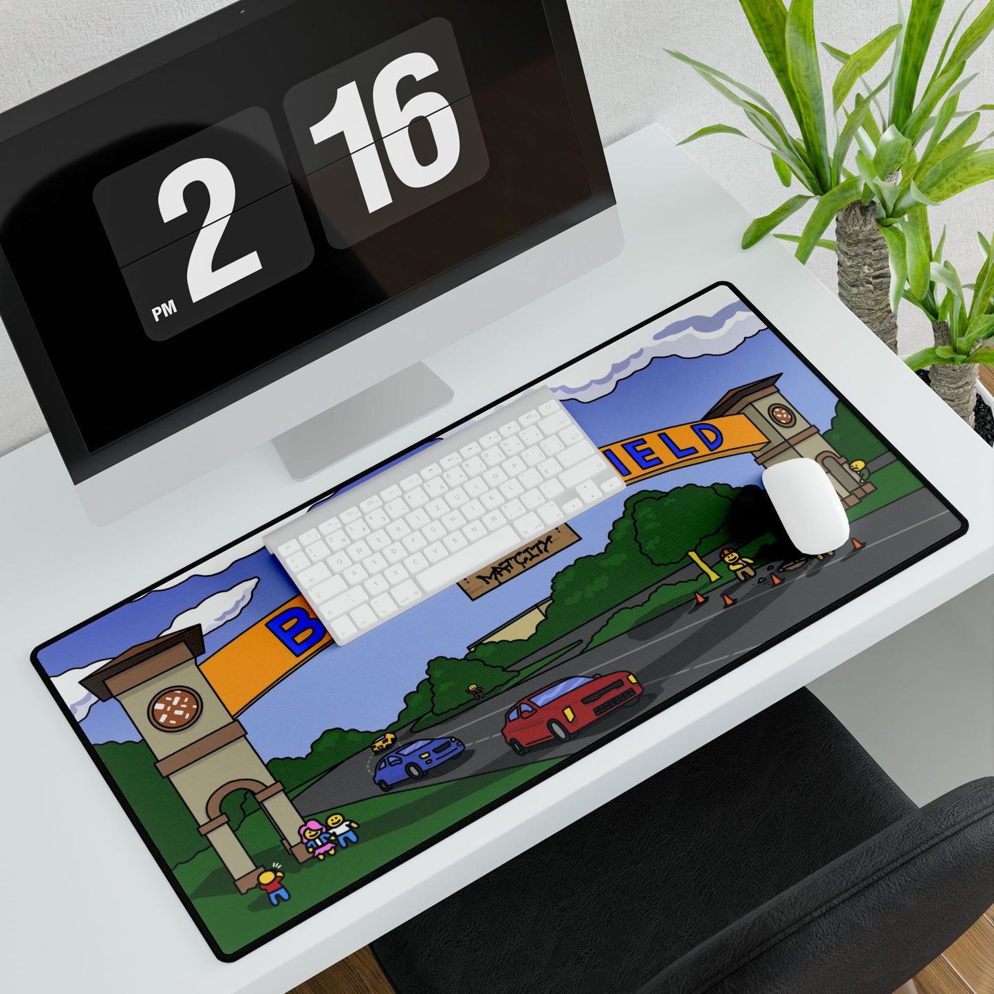 Mouse pad covering white desk beneath monitor and keyboard; the Bakersfield arch graphic stretches across, with vibrant cars and workers visible beside a white mouse.