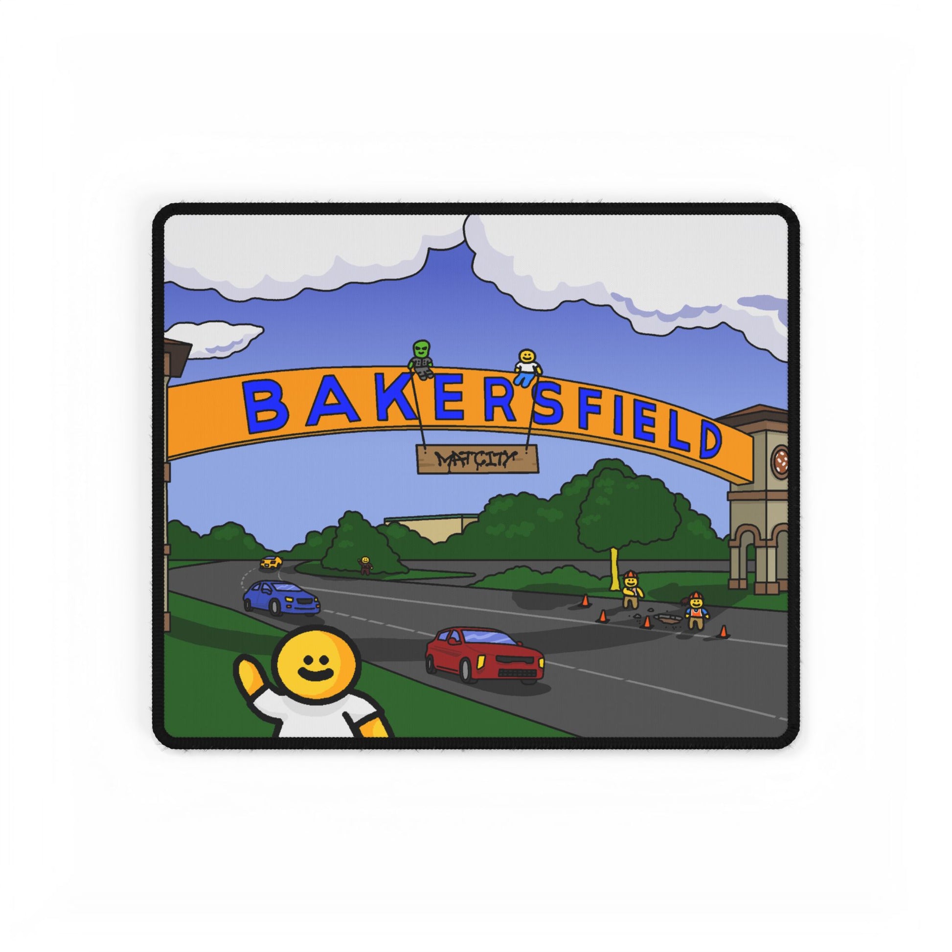 Compact mouse pad showing smiling yellow character waving in front of Bakersfield arch and speeding cars on a curved roadway.