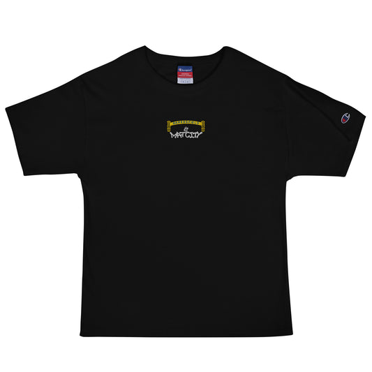 Black short‑sleeve Champion T‑shirt on white background. Tiny front‑center embroidery shows yellow Bakersfield arch, small worker figure, and white “Matcity” graffiti.