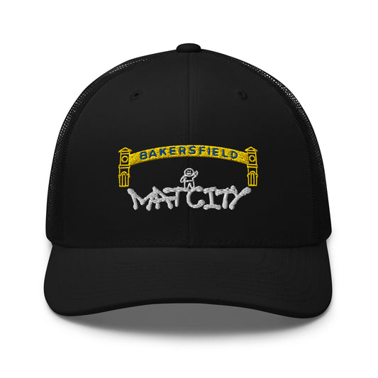 Black trucker cap with a yellow Bakersfield arch and small stick‑figure worker embroidered above white “Matcity” graffiti script on the front panel.