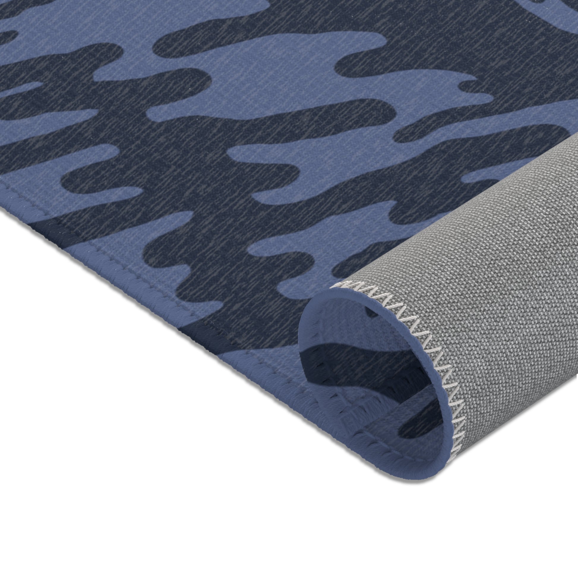 Blue Tieger camouflage patterned mat rolled showcasing the underside on a white background