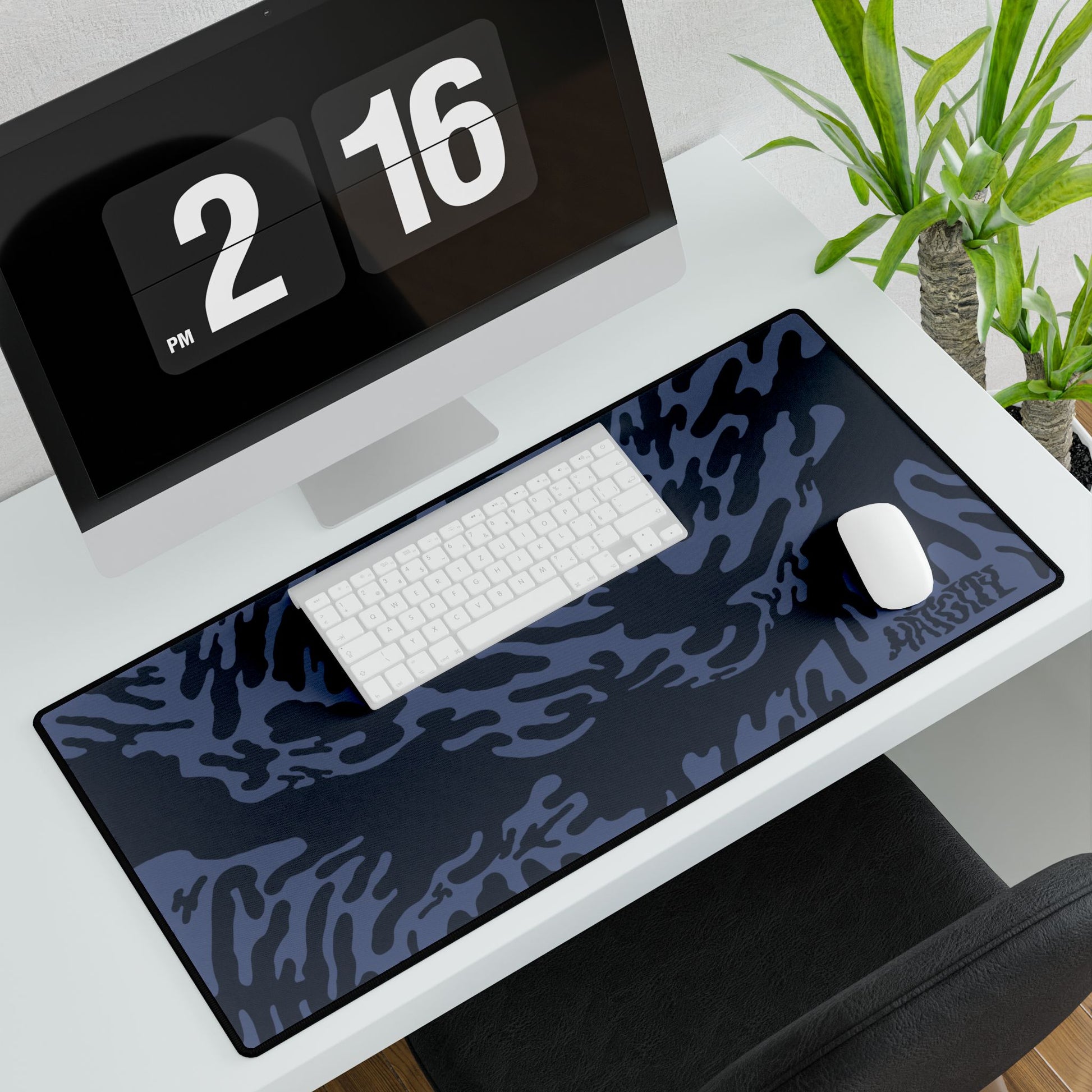Desk setup with a large Blue Tieger camouflage patterned mouse pad large, computer monitor, keyboard, and mouse.