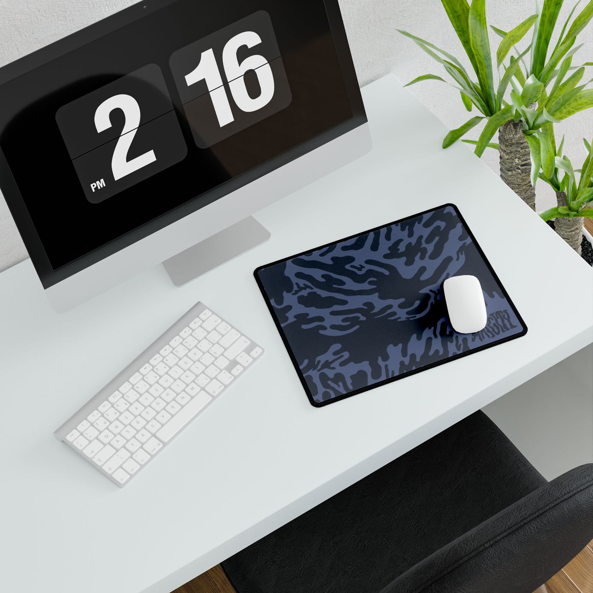 Desk setup with a small Blue Tieger camouflage patterned mouse pad small, computer monitor, keyboard, and mouse.