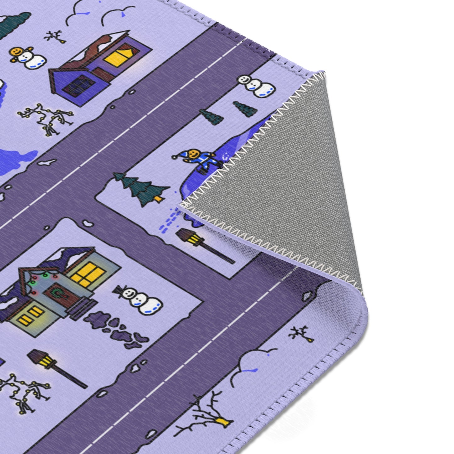 Close up of folded mat corner showing stitched edge, skating pond with elf, two mini snowmen, lit lamppost and snowy cottages on a road grid.