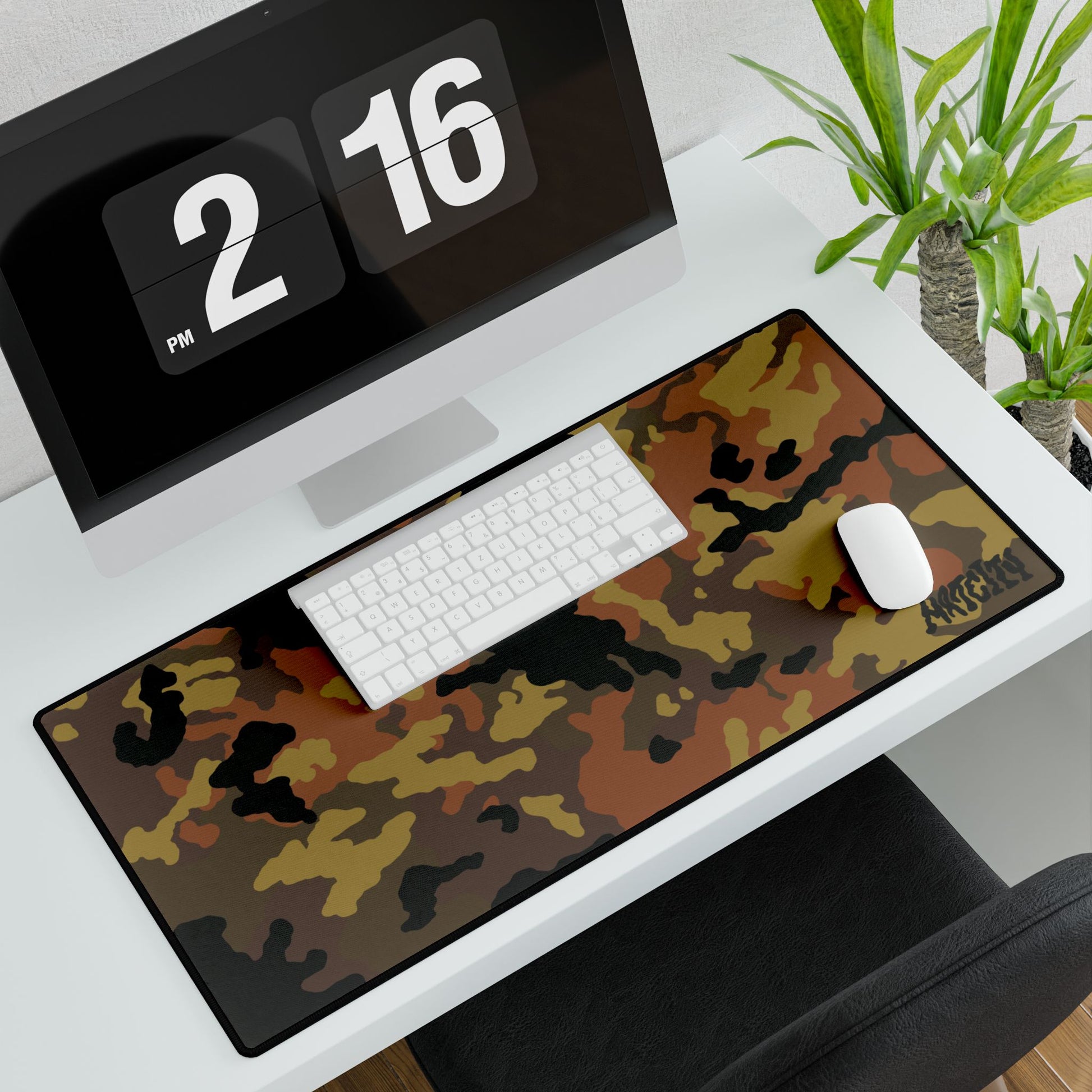 Fall Camouflage desk mat large on a desk with a computer and office items.