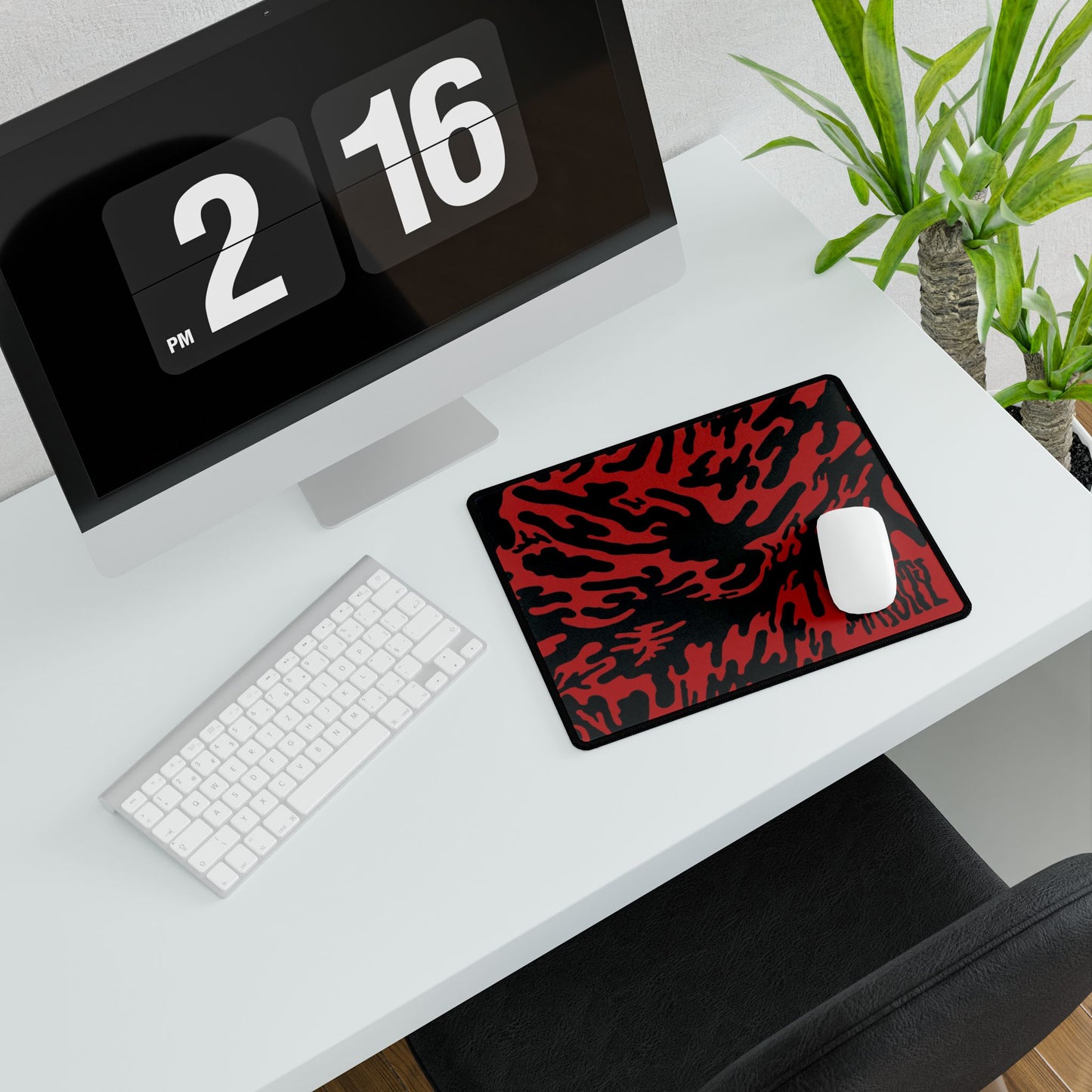 Desk setup with a large Red Tieger camouflage patterned mouse pad small, computer monitor, keyboard, and mouse.