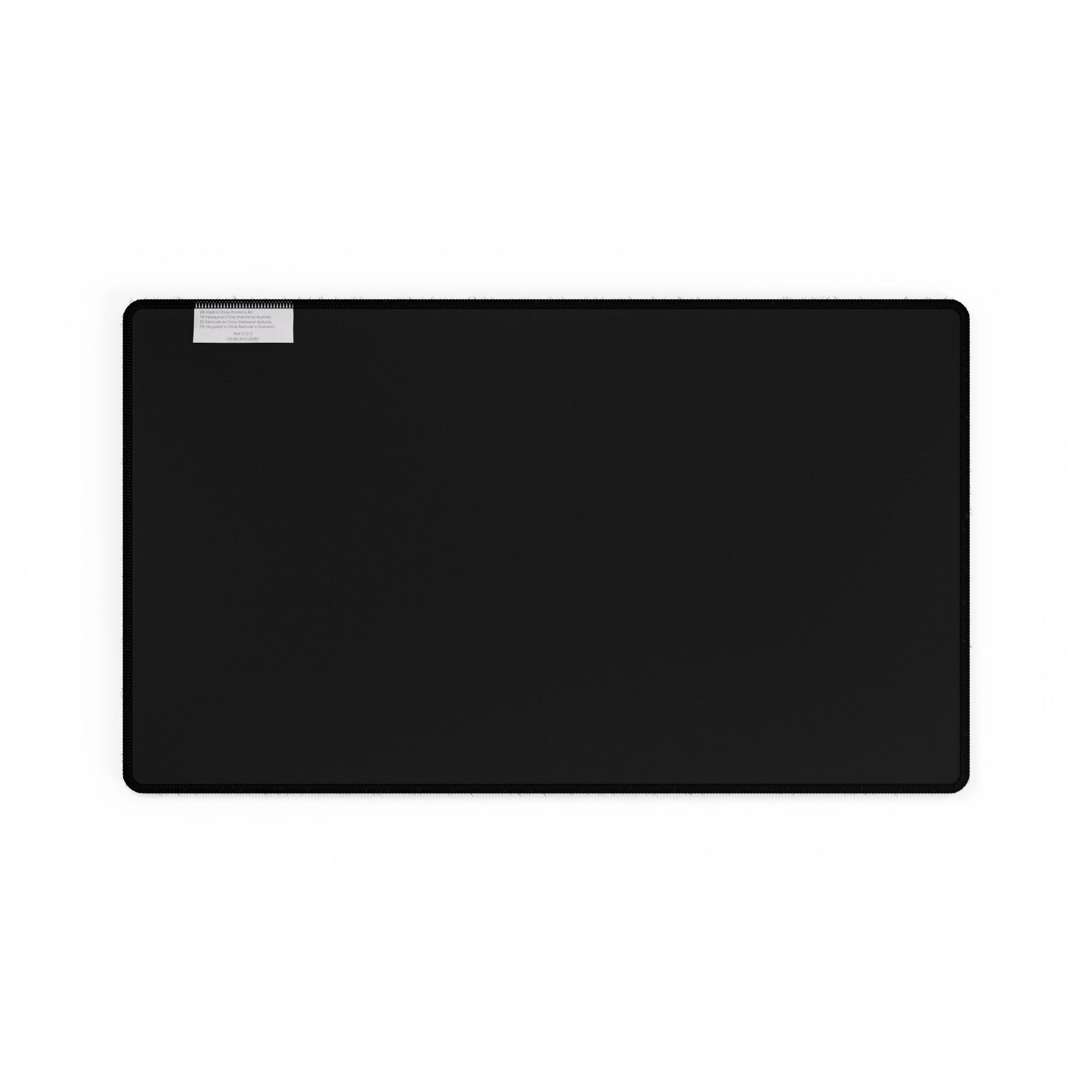 Black rectangular back side of a mouse pad on a white background